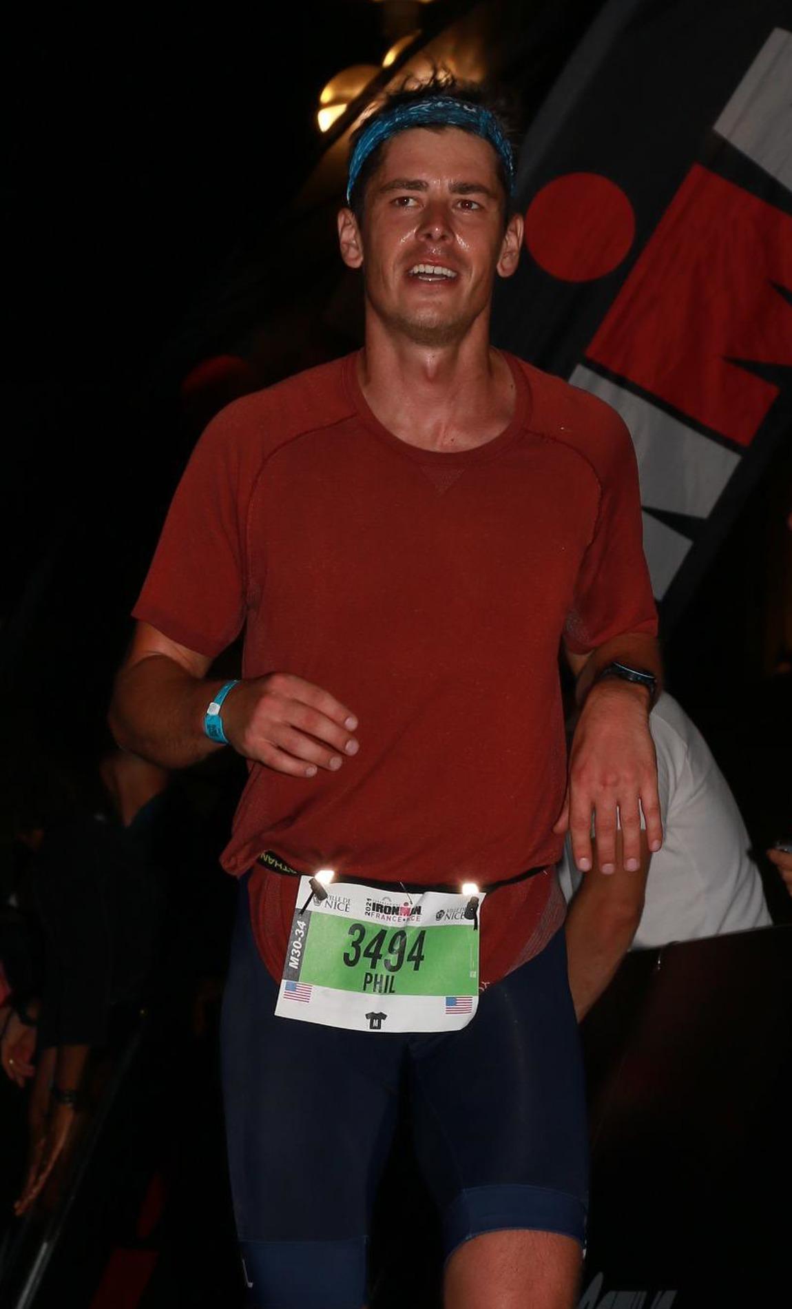 Phil running down the finish chute at Ironman France in Nice